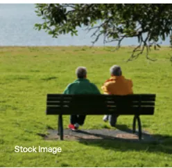Stock photograph of two seniors seated on a park bench, used as amenity mood imagery for Assetz Mizu and Ki